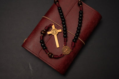 Overhead view of the St. Benedict crucifix and centerpiece medal on a handmade paracord rosary